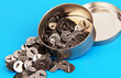 thumbtacks in a metal box.