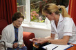 Panic alarm elderly woman being given instruction
