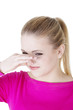 Woman covers nose with hand showing that something stinks