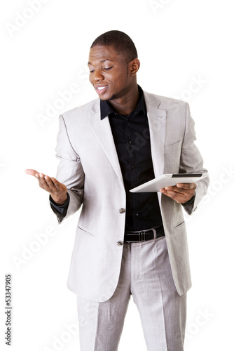 Photo: Handsome businessman working on tablet computer. Handsome businessman working on tablet computer.