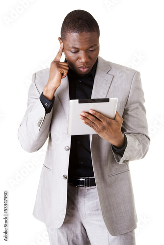 Photo: Handsome businessman working on tablet computer. Handsome businessman working on tablet computer.