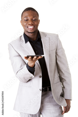 Photo: Handsome businessman working on tablet computer. Handsome businessman working on tablet computer.