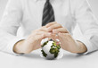 hands covering small earth