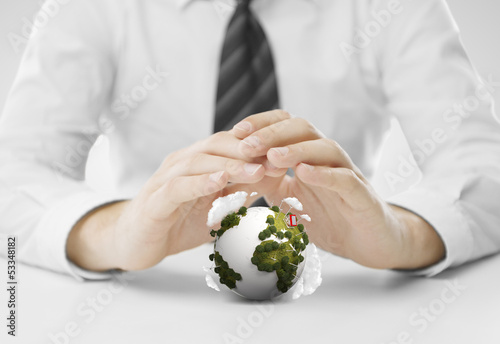 Photo: hands covering small earth hands covering small earth