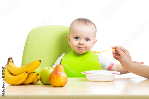 Photo: mother spoon feeding baby girl mother spoon feeding baby girl