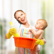 young happy mother is a housewife with a baby does homework and
