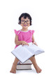 Photo: Cute girl reading book on white Cute girl reading book on white
