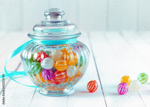 Photo: Colourful candy in a decorative jar Colourful candy in a decorative jar