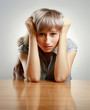 A young tired woman sitting at the desk