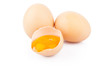 Chicken raw eggs, whole and broken on white, food photo