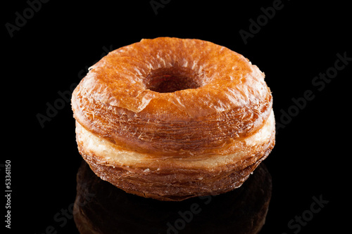 Photo: Croissant and doughnut mixture isolated on black Croissant and doughnut mixture isolated on black