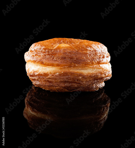 Photo: Croissant and doughnut mixture isolated on black Croissant and doughnut mixture isolated on black