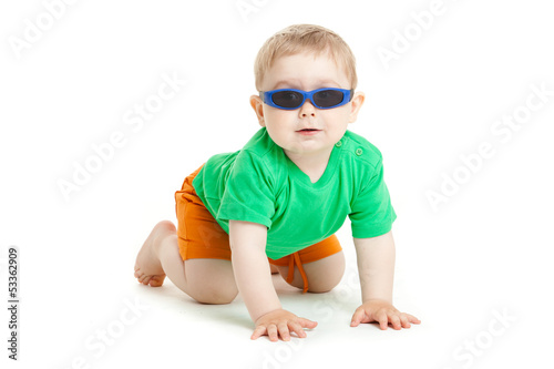 Photo: portrait of funny kid wearing sunglasses against a white backgro portrait of funny kid wearing sunglasses against a white backgro