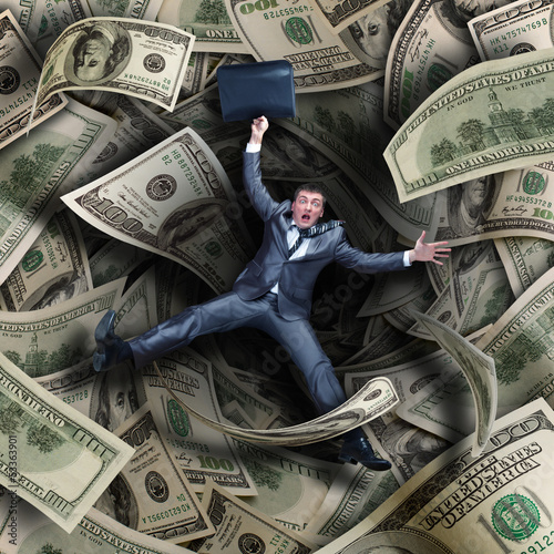 Photo: Businessman falling into financial tunnel Businessman falling into financial tunnel