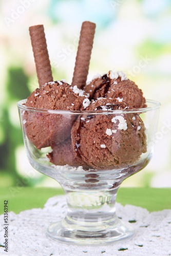 Photo: Delicious ice cream on table on bright background Delicious ice cream on table on bright background