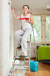 Photo: woman makes repairs at home woman makes repairs at home
