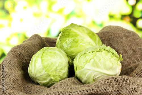 Photo: Green cabbage on sackcloth, on bright background Green cabbage on sackcloth, on bright background