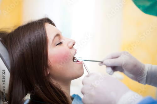 Photo: Dentist doing teeth checkup Dentist doing teeth checkup