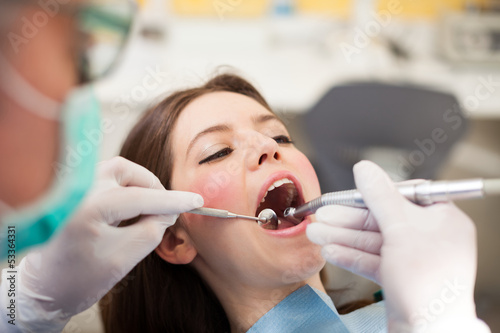 Photo: Dentist doing a dental treatment Dentist doing a dental treatment