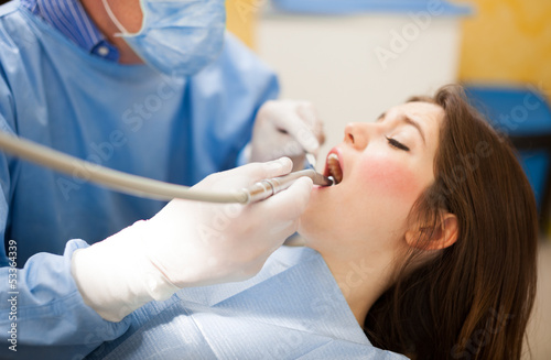 Photo: Dentist doing a dental treatment Dentist doing a dental treatment