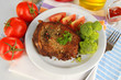 Foto: Piece of fried meat on plate isolated on white Piece of fried meat on plate isolated on white