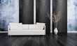 White couch in front of blue and black wall