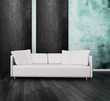 White couch in front of blue and black wall