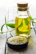Photo: sesame seeds and oil on a wooden table sesame seeds and oil on a wooden table