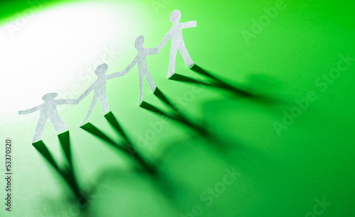 Photo: Paper people in teamworking concept Paper people in teamworking concept