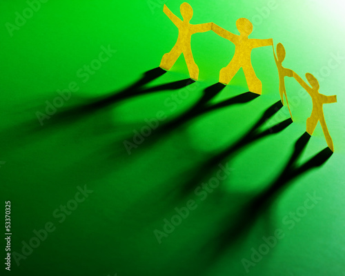 Photo: Paper people in teamworking concept Paper people in teamworking concept