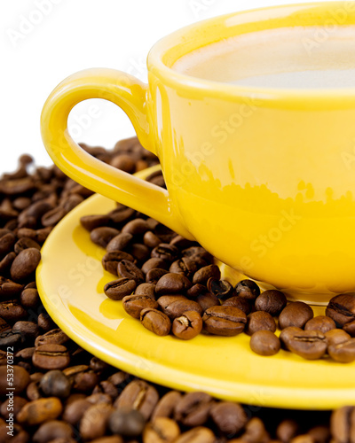 Photo: Coffee cup and beans on a white background. Coffee cup and beans on a white background.