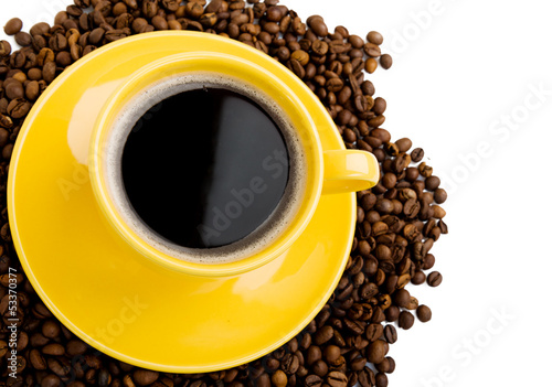 Photo: Coffee cup and beans on a white background. Coffee cup and beans on a white background.