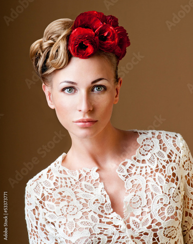 Photo: fashion model with hairstyle and flowers in her hair. fashion model with hairstyle and flowers in her hair.