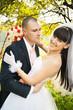 Groom holding leaning smiling bride