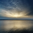 Foto: sunset over dark water sunset over dark water