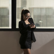 Photo: Attractive Chinese businesswoman using mobile phone Attractive Chinese businesswoman using mobile phone