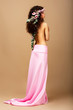 Tenderness. Gorgeous Curly Hair Brunette with Wreath of Flowers