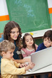 Photo: Teacher And Students Using Laptop In Class Teacher And Students Using Laptop In Class