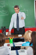 Mature Teacher Pointing At Students