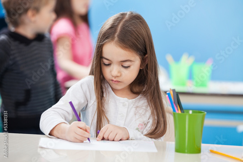 Photo: Cute Girl Drawing With Sketch Pen In Classroom Cute Girl Drawing With Sketch Pen In Classroom