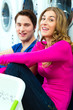 Photo: couple in a coin laundry washing couple in a coin laundry washing