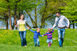Foto: Happy family running on summer meadow Happy family running on summer meadow