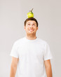man with green apple on his head