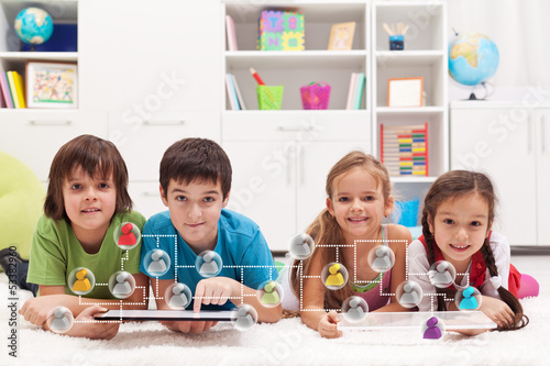 Photo: Happy kids connecting to social networks Happy kids connecting to social networks