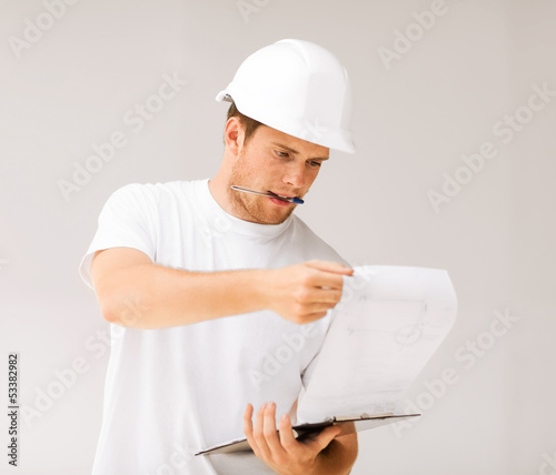 Photo: male architect looking at blueprint male architect looking at blueprint