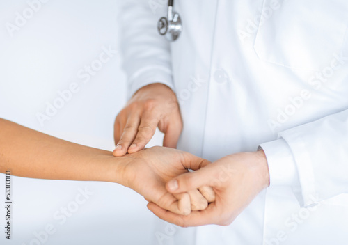 Photo: doctor measuring patient heart beat doctor measuring patient heart beat