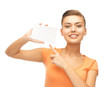 Photo: smiling woman pointing at white blank card smiling woman pointing at white blank card