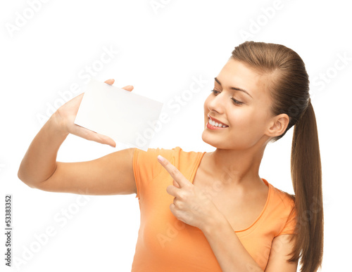 Photo: smiling woman pointing at white blank card smiling woman pointing at white blank card