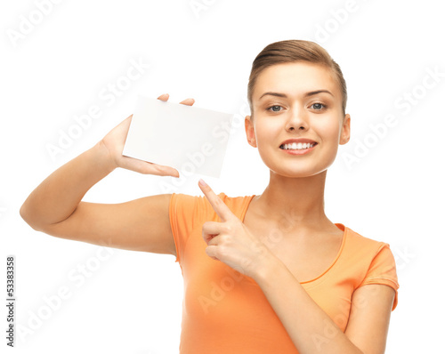 Photo: smiling woman pointing at white blank card smiling woman pointing at white blank card