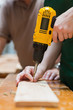 Photo: Drilling a hole in a wooden board Drilling a hole in a wooden board